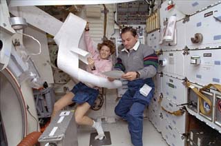 Collins and Titov posing with papers from the TIPS.